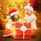 Happy kids in Santa hat opening a gift box