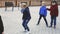 Happy kids skipping on chinese jump rope on playground in autumn day