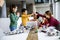 Happy kids with their African American female science teacher with laptop programming electric toys and robots at robotics