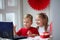 Happy kids waving, via laptop celebrating February 14 during quarantine, self-isolation and family values, online - Valentine`s