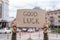 Happy kind wish. Good luck. Hand holding sign outside on street.