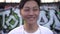 Happy kind young Asian male teenager smiling outdoors. Face of a positive Korean teenager