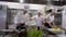 Happy kitchen crew with chef singing and dancing while cooking