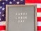 Happy Labor Day greetings on letter board with american flag