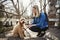 Happy Labradoodle Dog and woman outside at the park