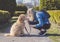 Happy Labradoodle Dog and woman outside at the park