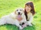 Happy labrador retriever dog and owner woman lying on the grass