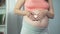 Happy lady expecting baby, holding heart shaped souvenir in hands, pregnancy