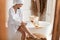 Happy Lady Shaving Legs And Chatting On Phone In Bathroom