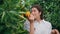 Happy lady smell citrus fruit at nature closeup. Woman enjoying orange aroma