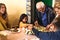 Happy Latin family having fun while preparing dinner together at home - Children spending time with grandparents during holidays