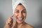 Happy Latin mature woman having skin care spa day