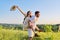 Happy laughing adult couple having fun outdoors, nature sky background