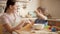 Happy laughing boy with playing with mother while cooking and throwing flour. Children cooking with parents, little chef