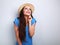 Happy laughing excited woman in hat looking up on blue background