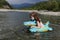 Happy laughing girl enjoying swimming in river with rubber ring crocodile