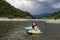 Happy laughing girl enjoying swimming in river with rubber ring crocodile. active summer vacation on the beach