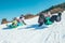 Happy laughing kids sliding down from the snow slope riding sleighs. Funny winter holidays spending concept image