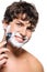 Happy laughing man shaving his face