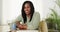 Happy laughing senior black woman sitting at desk