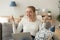 Happy laughing woman sitting on couch with laptop