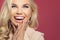 Happy laughing woman, young face closeup. Excited girl on colorful background with copy space