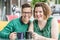 Happy lesbian couple sitting at table outside