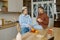 Happy LGBTQ couple lovers cooking together on home kitchen