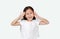 Happy little Asian child girl gestures playing peekaboo over white background. Kid posture open hands from eyes with smile