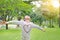 Happy little Asian child girl opened her hands and looking up in the fresh summer garden