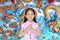 Happy little Asian child girl wearing pink traditional cheongsam dress with greeting gesture celebration for Chinese New Year on