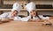 Happy little bakers behind counter in kitchen