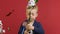 Happy little birthday boy with festive cone on his head celebrates his birthday explodes firecracker with confetti and