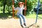 Happy little boy (2.11 years) swinging on playpit