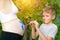 Happy little boy draws with a brush on the belly of his pregnant mom babyâ€™s footprint. Pregnant concept. Close-up