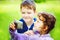 Happy little boy and girl taking self photo in the autumn park.