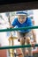 Happy little boy having fun in an urban playground, he climb on the green tube ladders