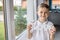 Happy little boy holding a wooden inscription with the word