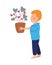 Happy little boy lifting houseplant