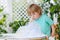 Happy little boy making experiment with colorful water and soap