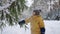 happy little boy is playing with spruce in forest in winter vacation, toddler is exploring nature