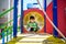 Happy little boy playing in tube or tunnel at the modern playground. Summer holidays. Happy and healthy childhood