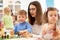 Happy little boy plays animal toys in kindergarten. Group of preschool kids on lesson in class