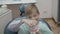 Happy little boy plays with plastic form of human jaw in dentist chair