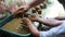 Happy little boy at a pottery art workshop, washing his dirty hands