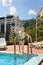 Happy little boy waving at the camera poolside