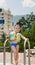 Happy little boy waving at the camera poolside