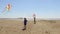 Happy little boys having fun and flying kites on the beach