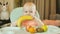 Happy little child bite a banana. Healthy food concept. Baby eating fruits. Cute red-haired girl eating a banana in