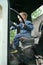 Happy little child boy playing inside old vintage truck car, holding big wheel. Slow life in countryside. Happy childhood concept